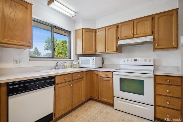 6411 W 82nd Dr, Arvada, CO 80003 - kitchen featuring white appliances, under cabinet range hood, light countertops, and brown cabinetry