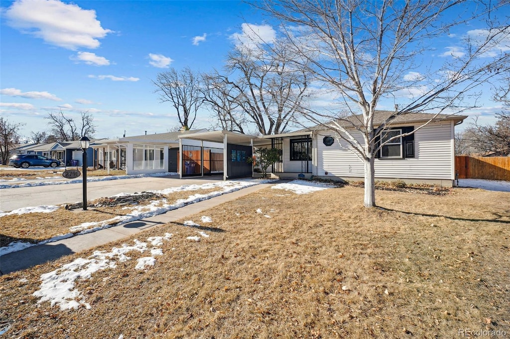 view of front of property with a front yard and a carport