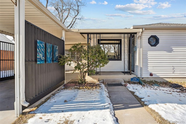 view of snow covered property entrance