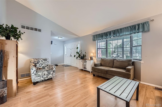 living room featuring visible vents, baseboards, and light wood-type flooring