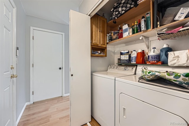 laundry room featuring light wood-style floors and washing machine and dryer