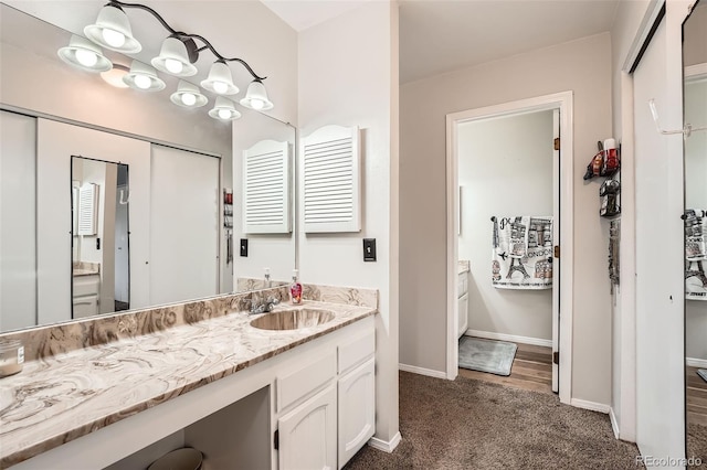 bathroom with vanity and baseboards