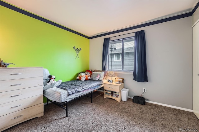 carpeted bedroom featuring baseboards and ornamental molding