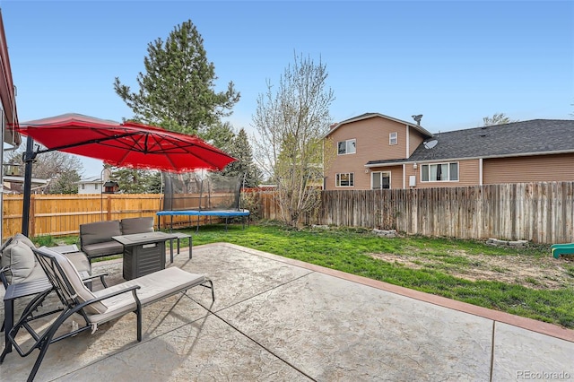 view of patio with a fenced backyard and a trampoline