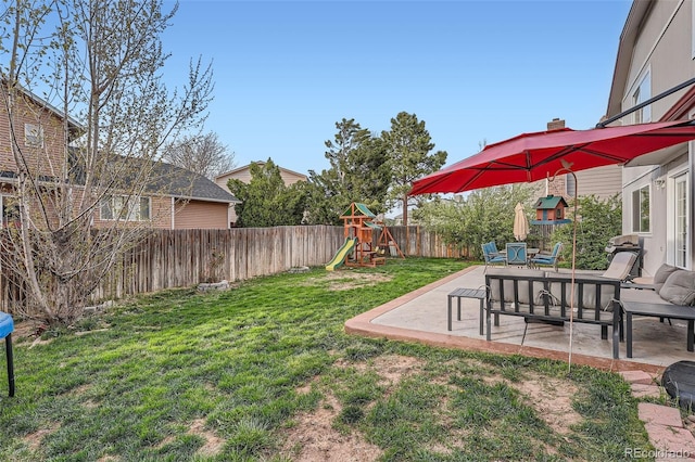 view of yard featuring a fenced backyard, a playground, and a patio area