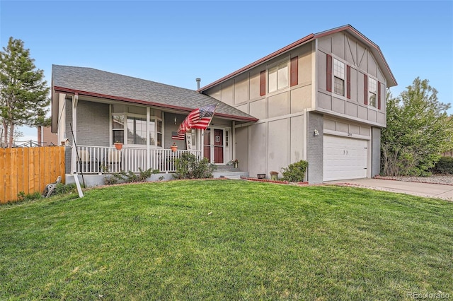 tri-level home with covered porch, driveway, a front yard, a garage, and brick siding