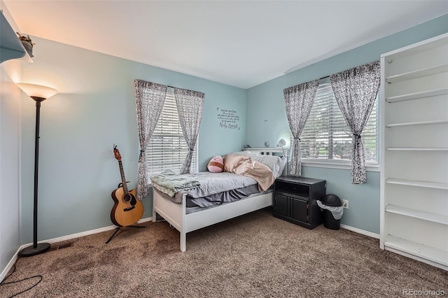 carpeted bedroom featuring baseboards