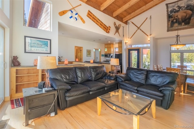 living room with beam ceiling, light hardwood / wood-style floors, high vaulted ceiling, and wooden ceiling