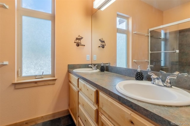 bathroom featuring tile patterned flooring, vanity, and walk in shower