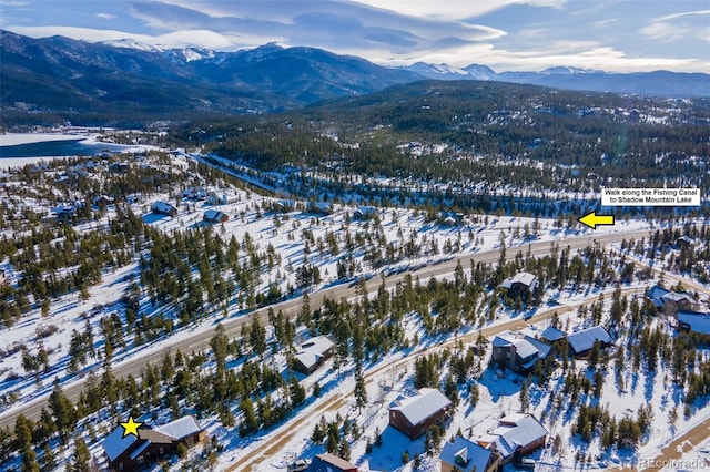 snowy aerial view with a mountain view