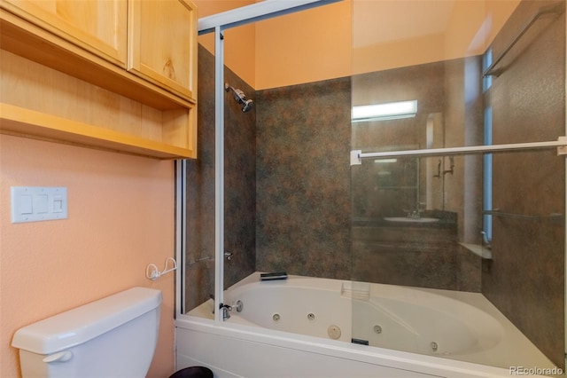 full bathroom with sink, tiled shower / bath combo, and toilet