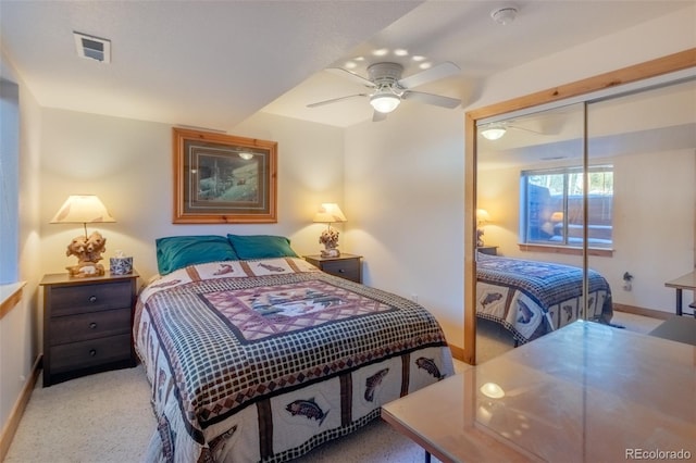 bedroom with light colored carpet, a closet, and ceiling fan