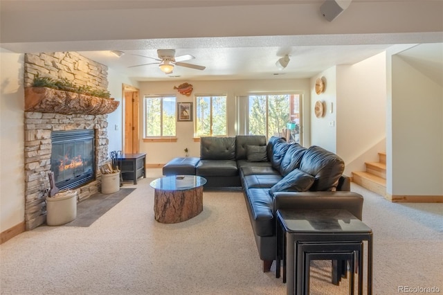 385 Trail Ridge Dr, Grand Lake, CO 80447 - living area with carpet, baseboards, ceiling fan, stairway, and a fireplace