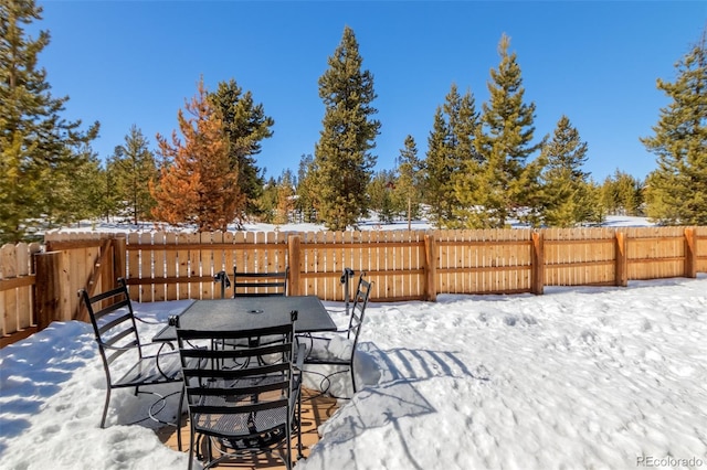 snow covered deck featuring fence private yard and outdoor dining area