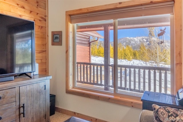 doorway with a mountain view and baseboards