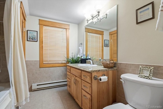 bathroom with tile walls, vanity, baseboard heating, walk in shower, and toilet