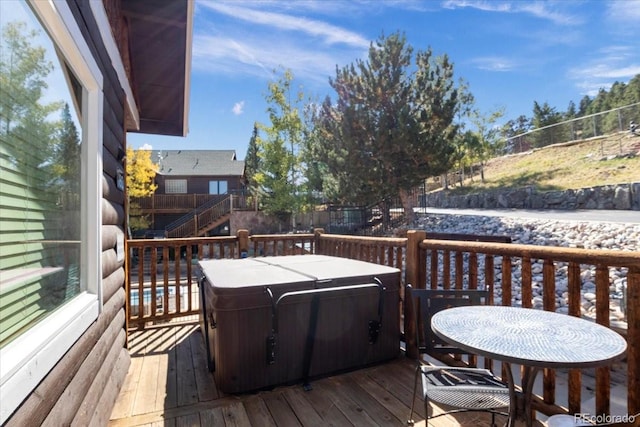 wooden terrace featuring a hot tub