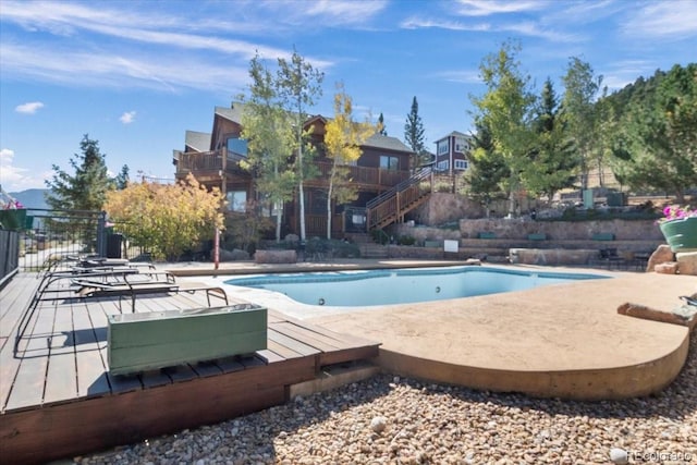 view of pool featuring a deck and a patio area