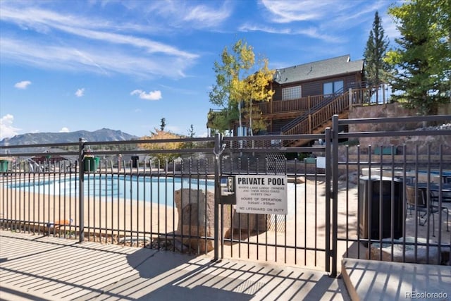 view of swimming pool with a mountain view