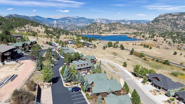 birds eye view of property with a water and mountain view