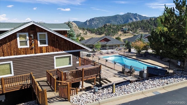 view of pool featuring a deck with mountain view and a patio