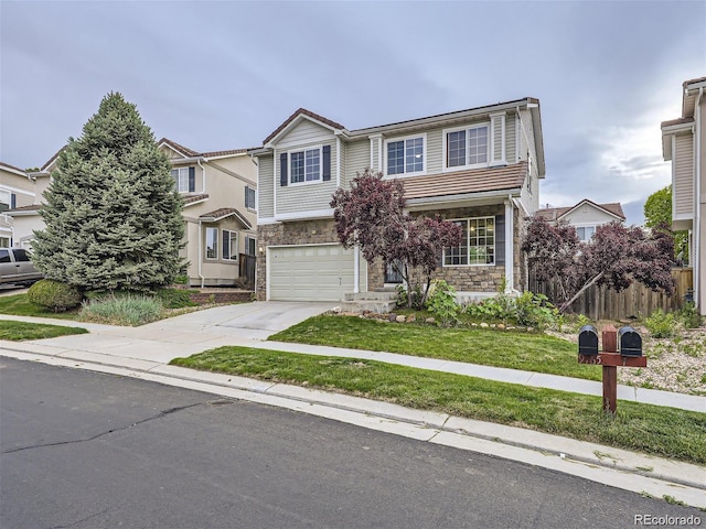 view of front of property featuring a garage and a front yard