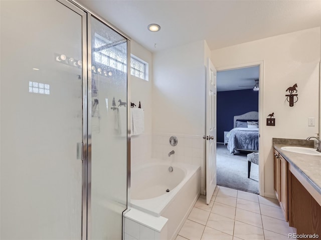 bathroom featuring tile patterned flooring, vanity, and separate shower and tub