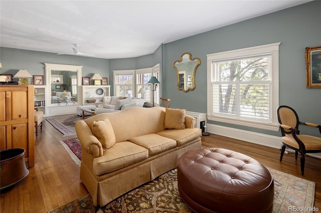 living room with baseboards and wood finished floors