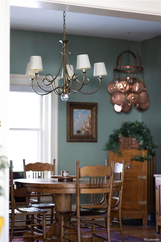 dining room featuring a notable chandelier and wood finished floors