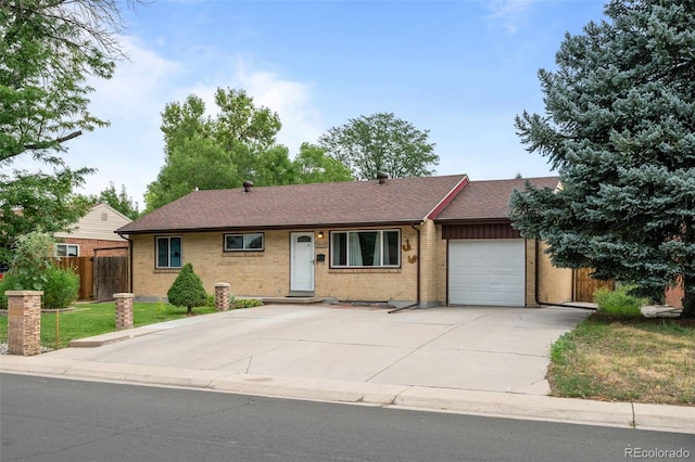 single story home featuring a garage, brick siding, a shingled roof, fence, and driveway