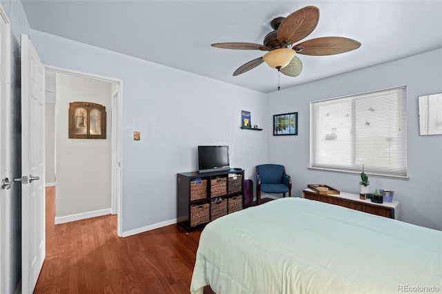 bedroom with dark wood-type flooring, baseboards, and a ceiling fan