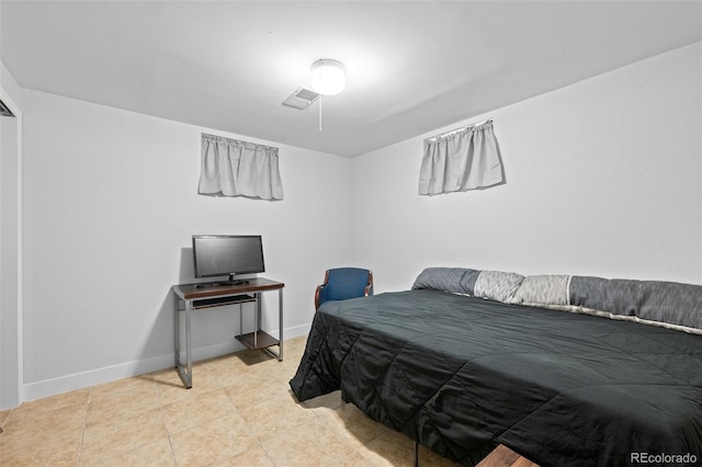 tiled bedroom featuring visible vents and baseboards