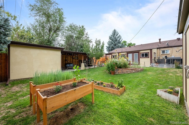 view of yard with fence and a garden