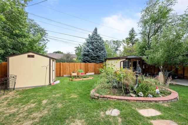 view of yard featuring an outbuilding, a shed, and a fenced backyard