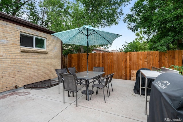 view of patio / terrace featuring outdoor dining space, grilling area, and fence