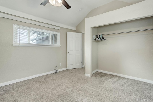 unfurnished bedroom with lofted ceiling, carpet, ceiling fan, and a closet