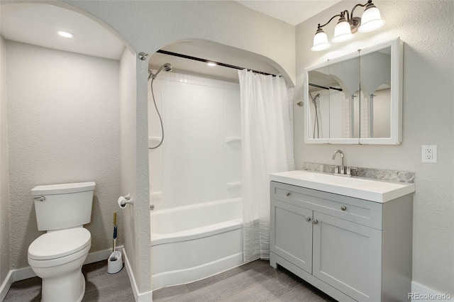 full bathroom featuring wood-type flooring, toilet, vanity, and shower / bath combo