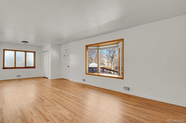 unfurnished living room featuring light wood-type flooring