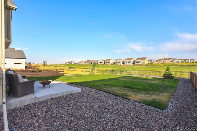 view of yard featuring a patio and a fire pit