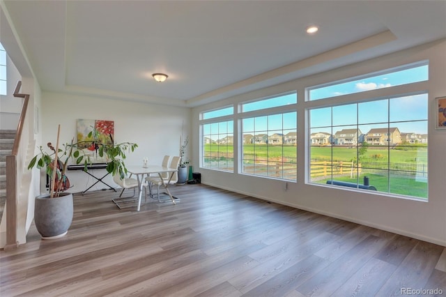 unfurnished sunroom featuring a tray ceiling