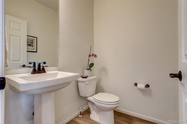 bathroom featuring hardwood / wood-style floors, toilet, and sink