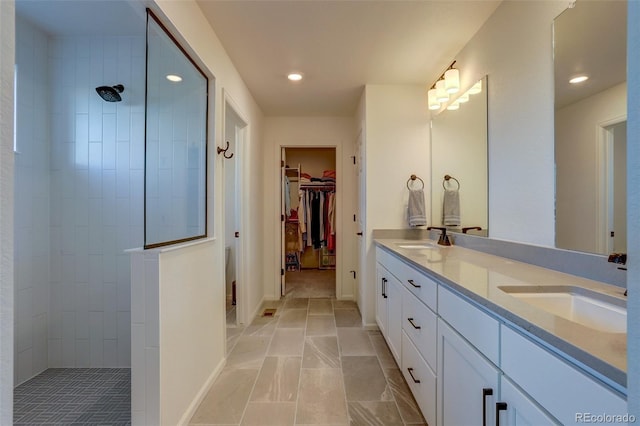 bathroom featuring vanity and a tile shower