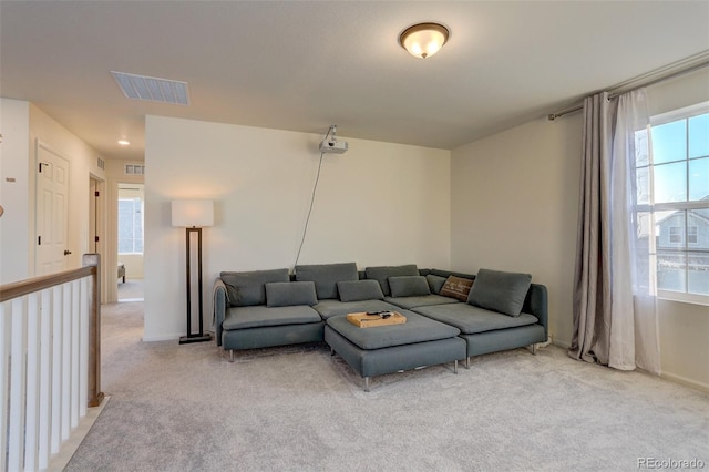 carpeted living room with a healthy amount of sunlight