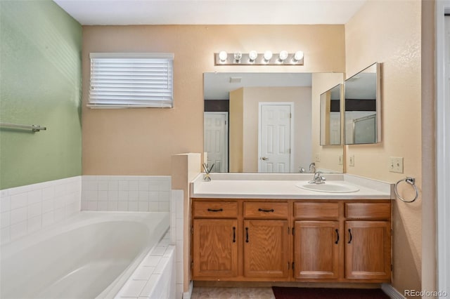 bathroom with vanity and tiled bath