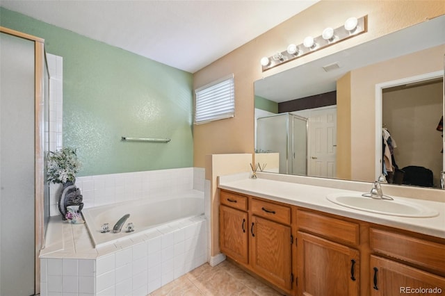 bathroom featuring independent shower and bath, vanity, and tile patterned flooring