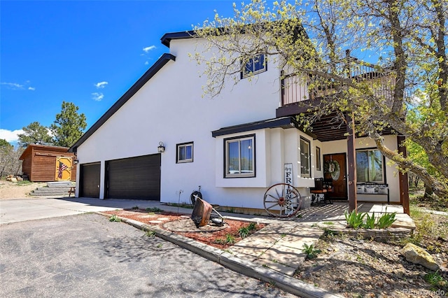 1673 Woodmoor Dr, Monument, CO 80132 - view of front of property with stucco siding and driveway