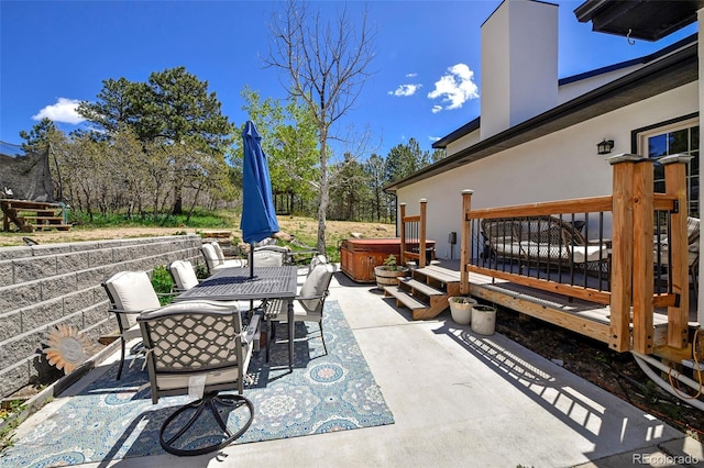 1673 Woodmoor Dr, Monument, CO 80132 - view of patio featuring a hot tub, outdoor dining area, and a deck