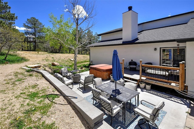 1673 Woodmoor Dr, Monument, CO 80132 - view of patio featuring a hot tub, outdoor dining space, and a wooden deck