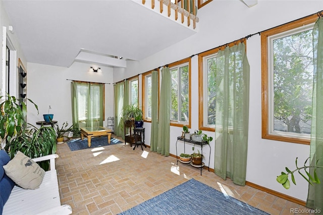 1673 Woodmoor Dr, Monument, CO 80132 - sunroom / solarium with healthy amount of natural light, baseboards, and brick patterned floors