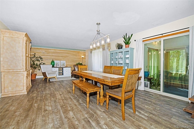 1673 Woodmoor Dr, Monument, CO 80132 - dining area with wood finished floors, wooden walls, and a chandelier